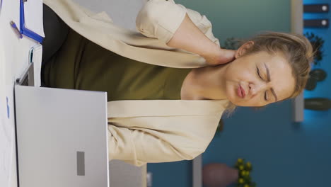 Vertical-video-of-Home-office-worker-woman-has-neck-pain.